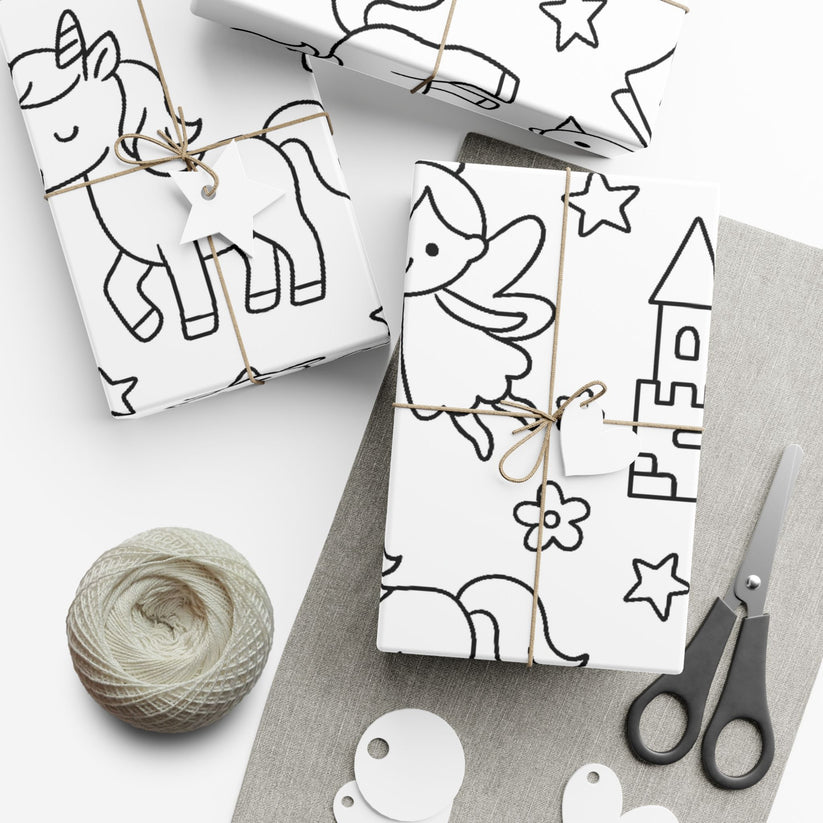 Gift wrap with princess themed black line art on white paper, tied with string, scissors, and yarn on a white surface.