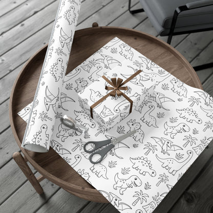 Dinosaur patterned gift wrap with scissors on a wooden table