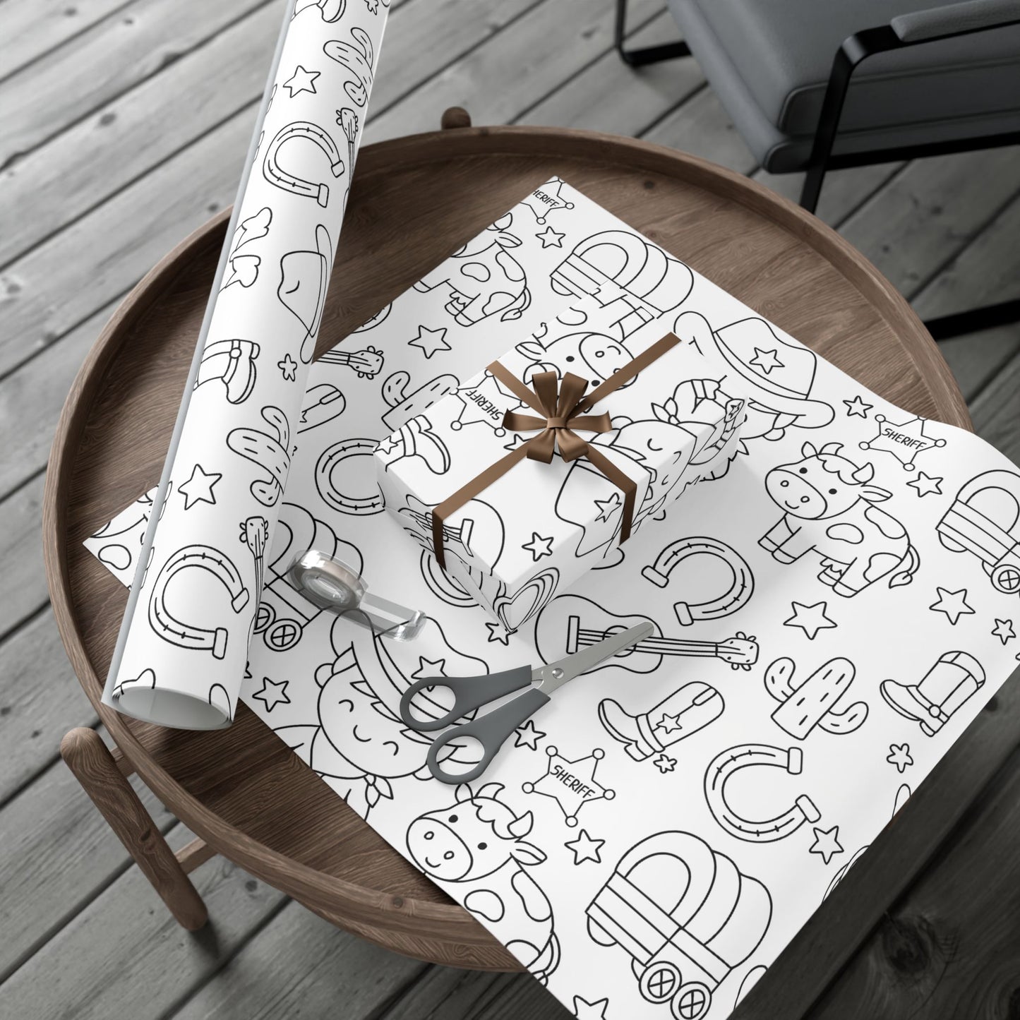 Gift wrap with cowboy-themed design on a wooden table