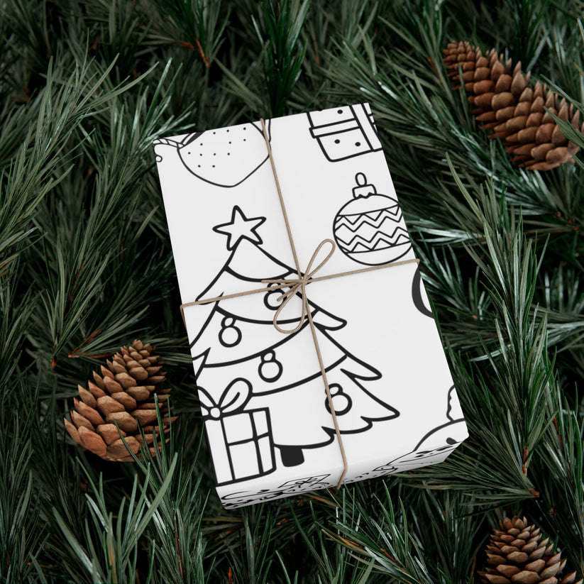 Gift wrapped in black and white patterned paper with Christmas elements made to be colored in, tied with brown string, on green pine needles with pine cones.