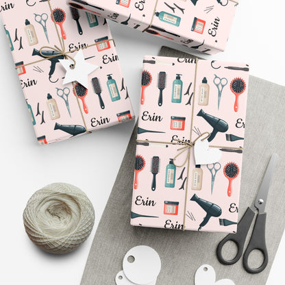 Gift boxes wrapped in hair salon-themed paper with scissors and yarn on a white surface