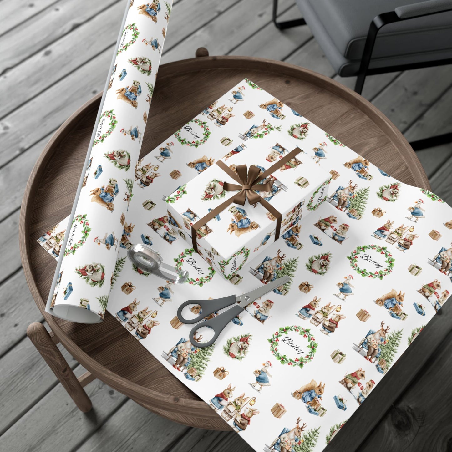 Wrapping paper with a Victorian Animal Christmas theme sitting on a table with a roll of matching paper.