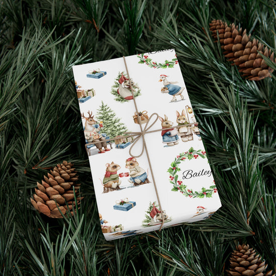 Christmas Victorian animal themed gift wrap personalized with Bailey, sitting on a bed of pine needles.
