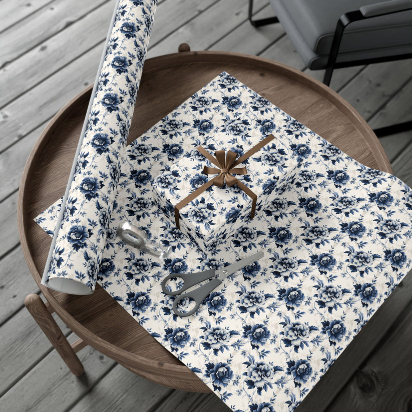 Floral-patterned gift wrap with scissors on a wooden table