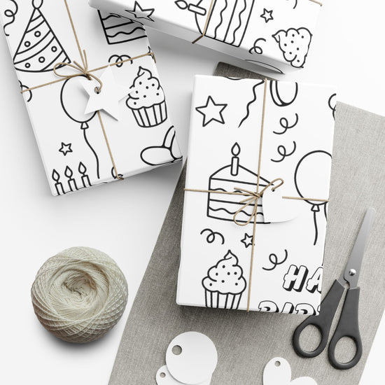 Black and white birthday-themed coloring wrapping paper featuring cakes, balloons, party hats, and stars, designed for kids gift wrap and party activity.