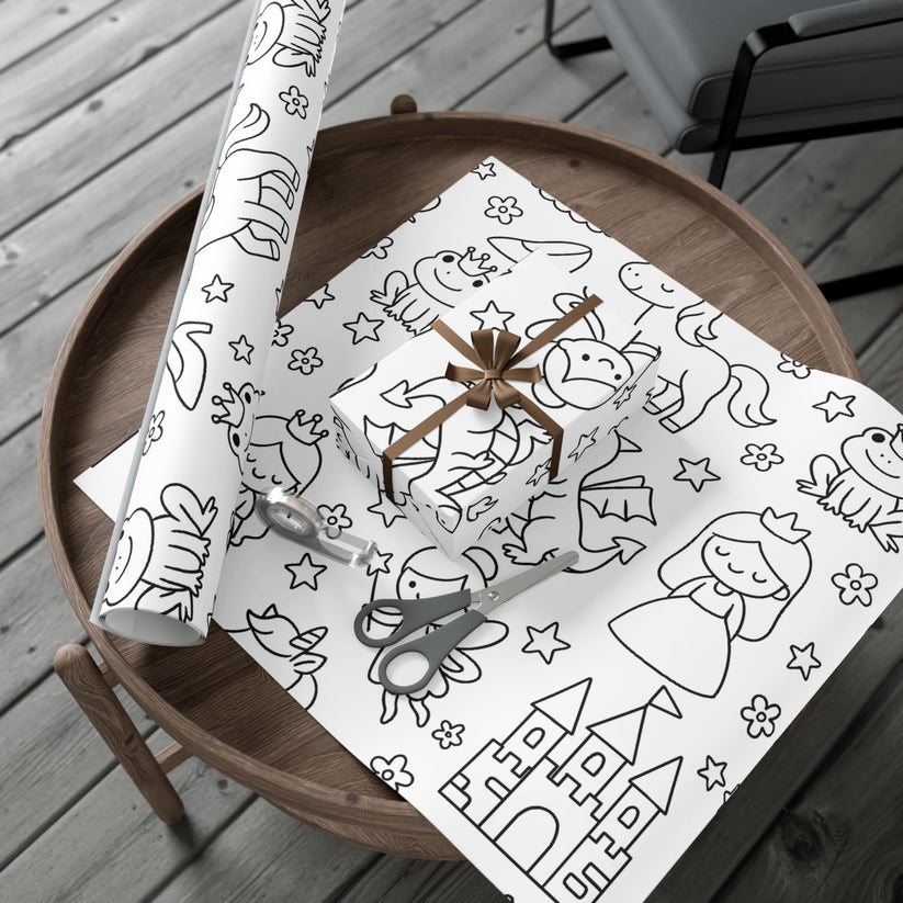 Wooden table with a roll of black and white princess themed coloring wrapping paper on top