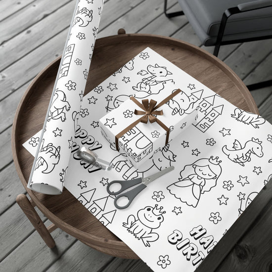 Princess themed coloring wrapping paper roll on a table with flat piece of wrapping paper and box wrapped.