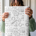 Person holding a coloring wrapping paper with western-themed illustrations
