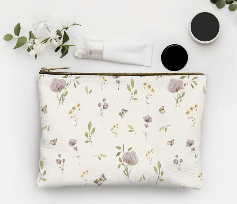 Floral-patterned pouch with cosmetic items on a light background