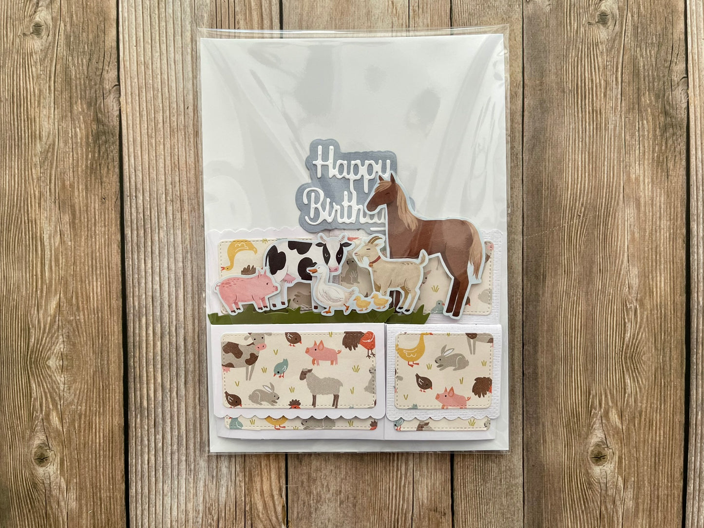 Birthday card with animal illustrations on a wooden background
