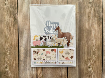Birthday card with animal illustrations on a wooden background
