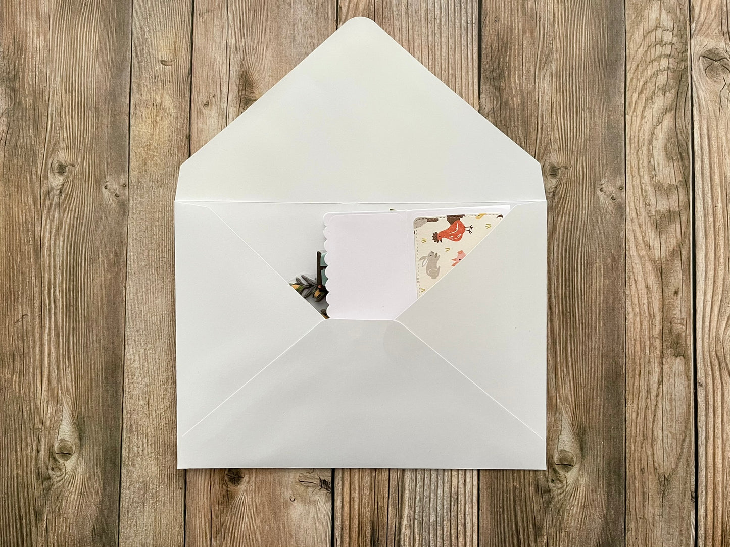 White envelope with a card on a wooden surface