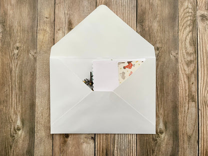White envelope with a card on a wooden surface