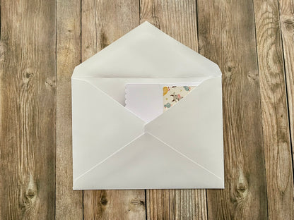White envelope with a card on a wooden surface