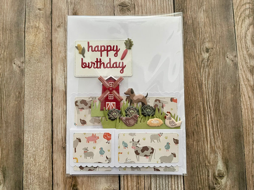 Birthday card with farm-themed illustrations on a wooden surface