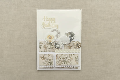 Decorative birthday card with floral designs and 'Happy Birthday' text on a black marble background.
