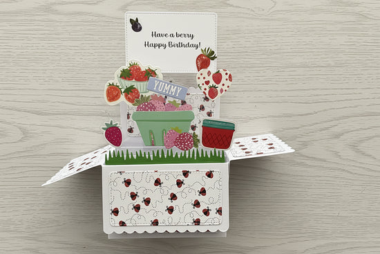 Pop-up card with strawberry theme on a marble surface