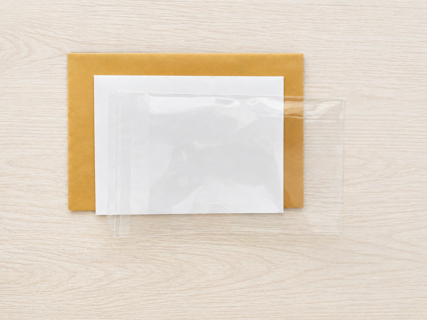 Cellophane envelope, white envelope and mailing envelope for cards.