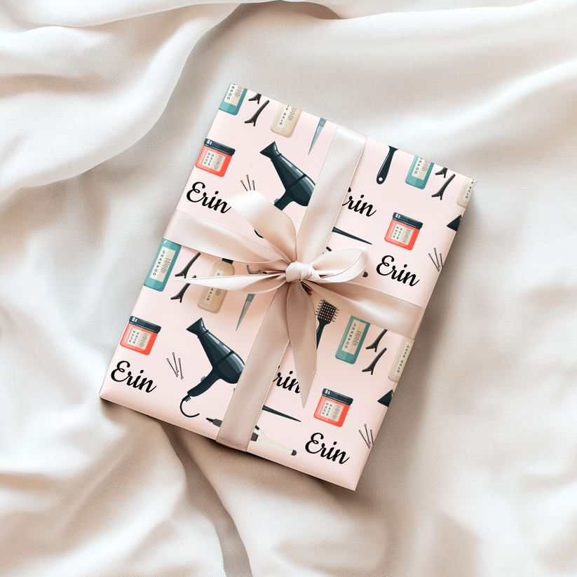 Gift box with hair dressing tools themed wrapping paper and personalized with 'Erin' on a soft fabric background