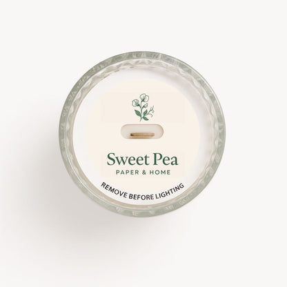 Candle with 'Sweet Pea' branding on a white background