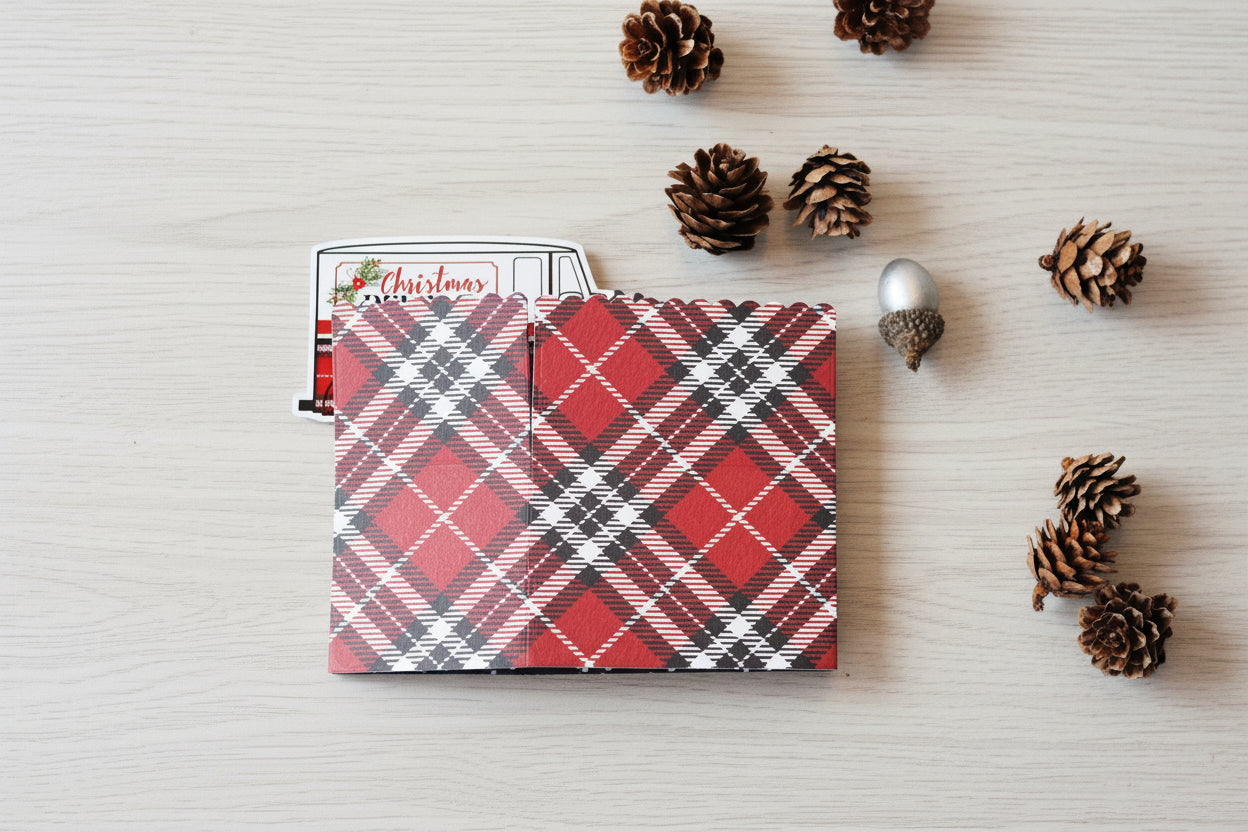 Box style pop-up card folded.  Red, black and white plaid pattern on the background.
