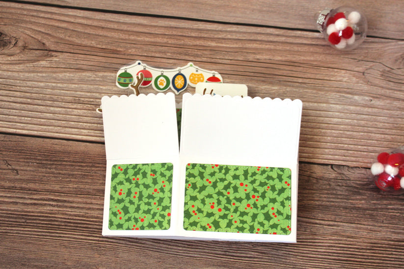 Folded paper with green pattern on a wooden surface