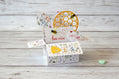 Pop-up Valentine's Day card with honeycomb design and heart-shaped elements on a wooden surface.