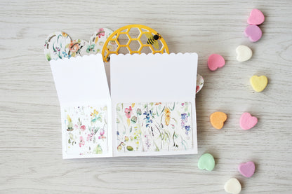 Valentine's Day box style pop-up card with bee theme, folded on a white wooden surface.