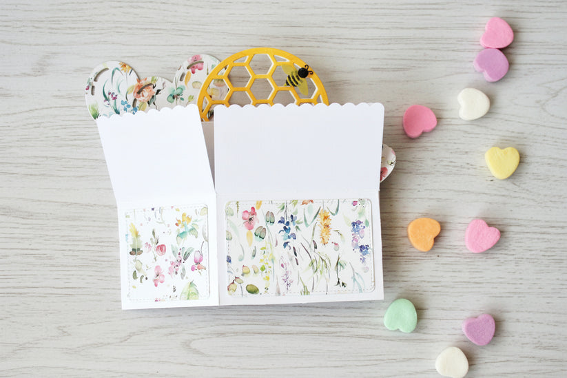 Valentine's Day box style pop-up card with bee theme, folded on a white wooden surface.