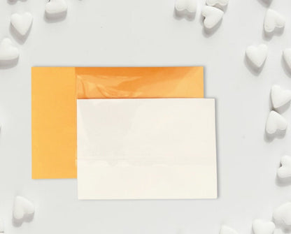 Two square cards, one orange and one white, on a light gray background with white heart shapes.