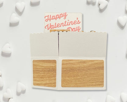 Wooden palette with 'Happy Valentine's Day' card on a white background