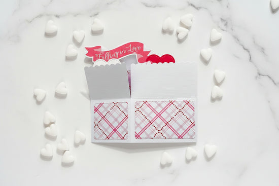 Notebook with plaid patterns and a 'Falling in Love' banner on a white background