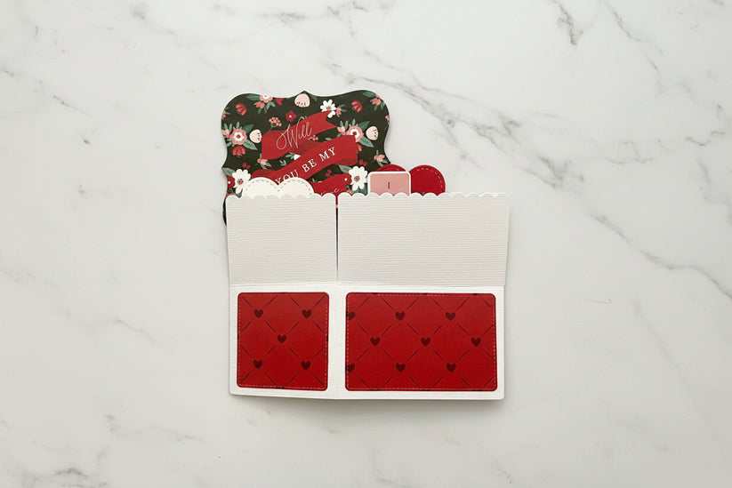 Card holder with floral design and red heart pattern on a white background