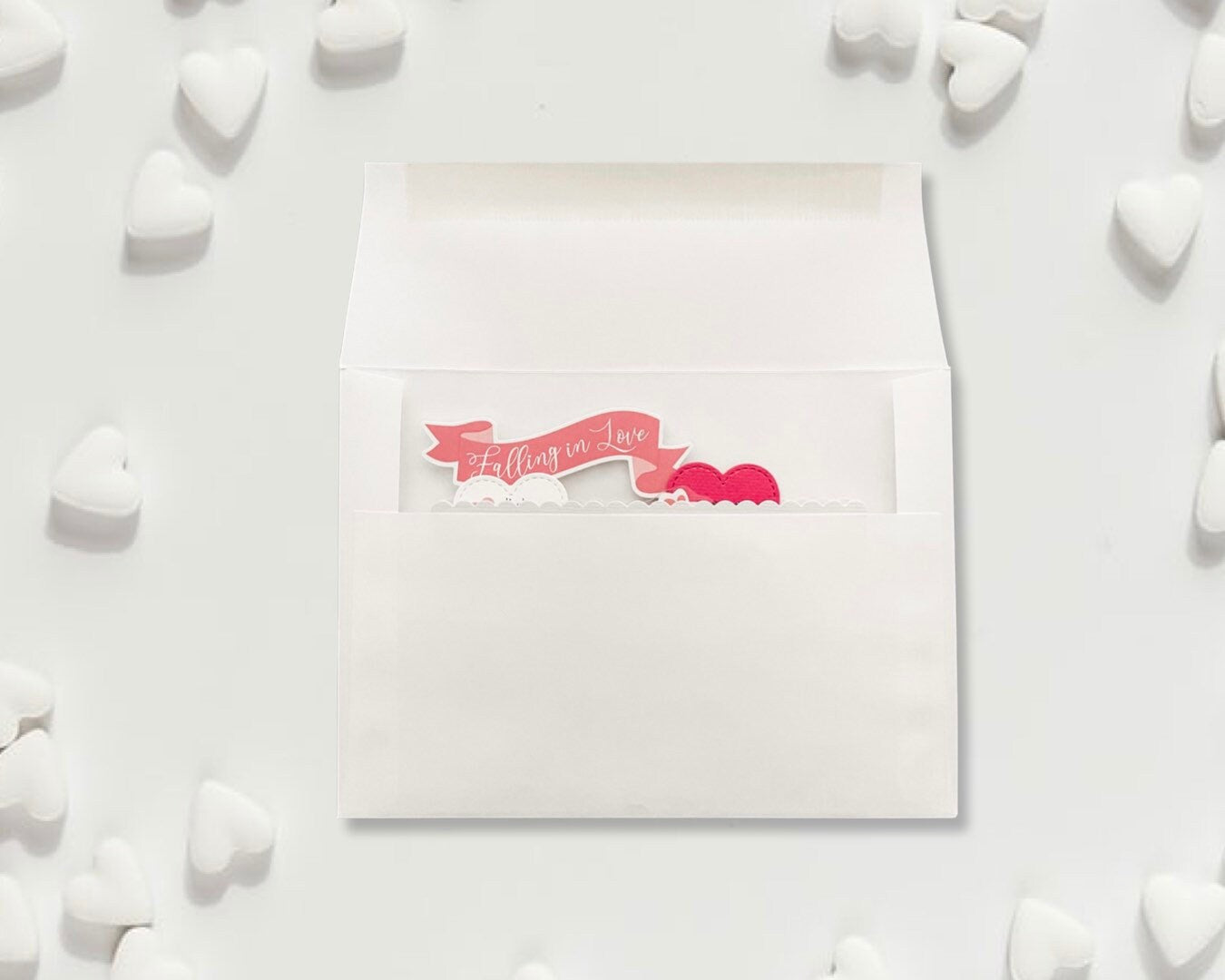 White card with pink text and hearts on a white background
