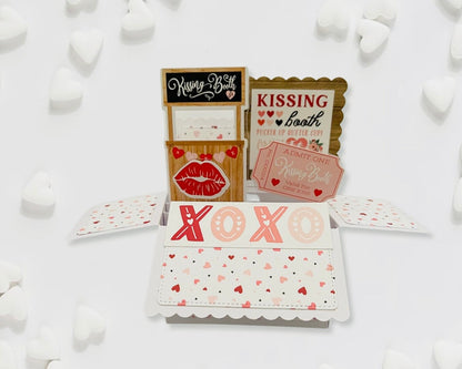 Valentine's Day card with kissing booth design on a white background with heart decorations.