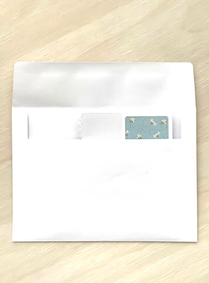 White envelope with a decorative flap on a wooden surface