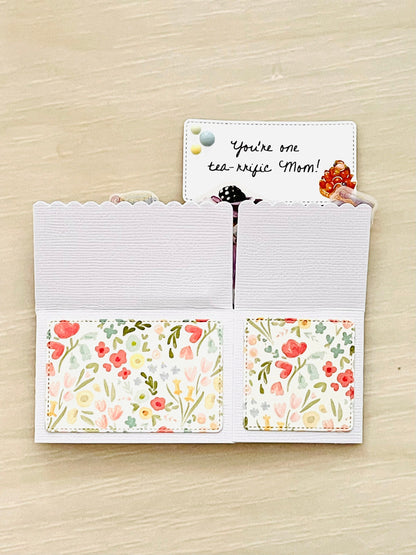Mother's day pop-up card with tea party theme.  Floral accents and message of You're one tea-rrific mom.
