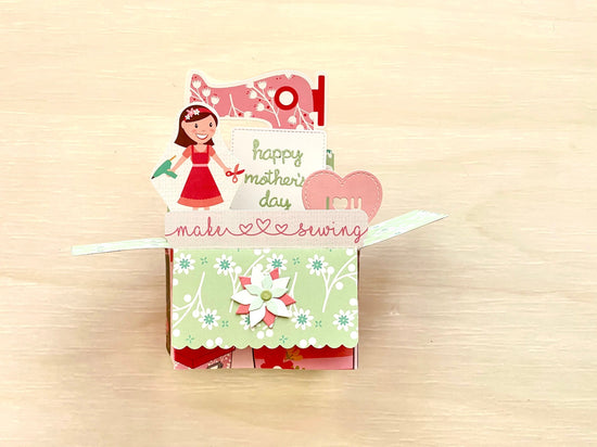 Pop-up card with a mother and her crafting tools design on a beige background