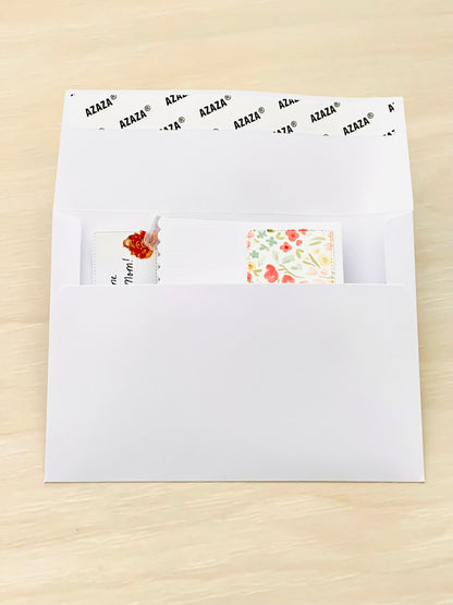 White envelope with Mother's Day pop-up card on a beige surface