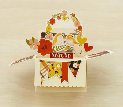 Decorative card with flowers, birds, and 'XOXO' text on a beige background