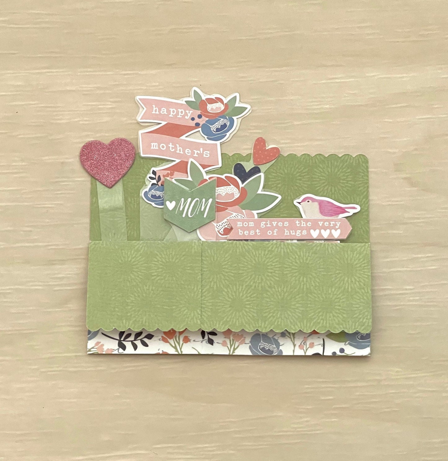 Decorative card with 'Happy Mother's Day' text on a wooden surface