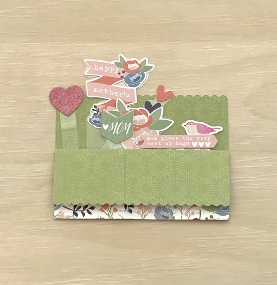 Decorative card with 'Happy Mother's Day' text on a wooden surface