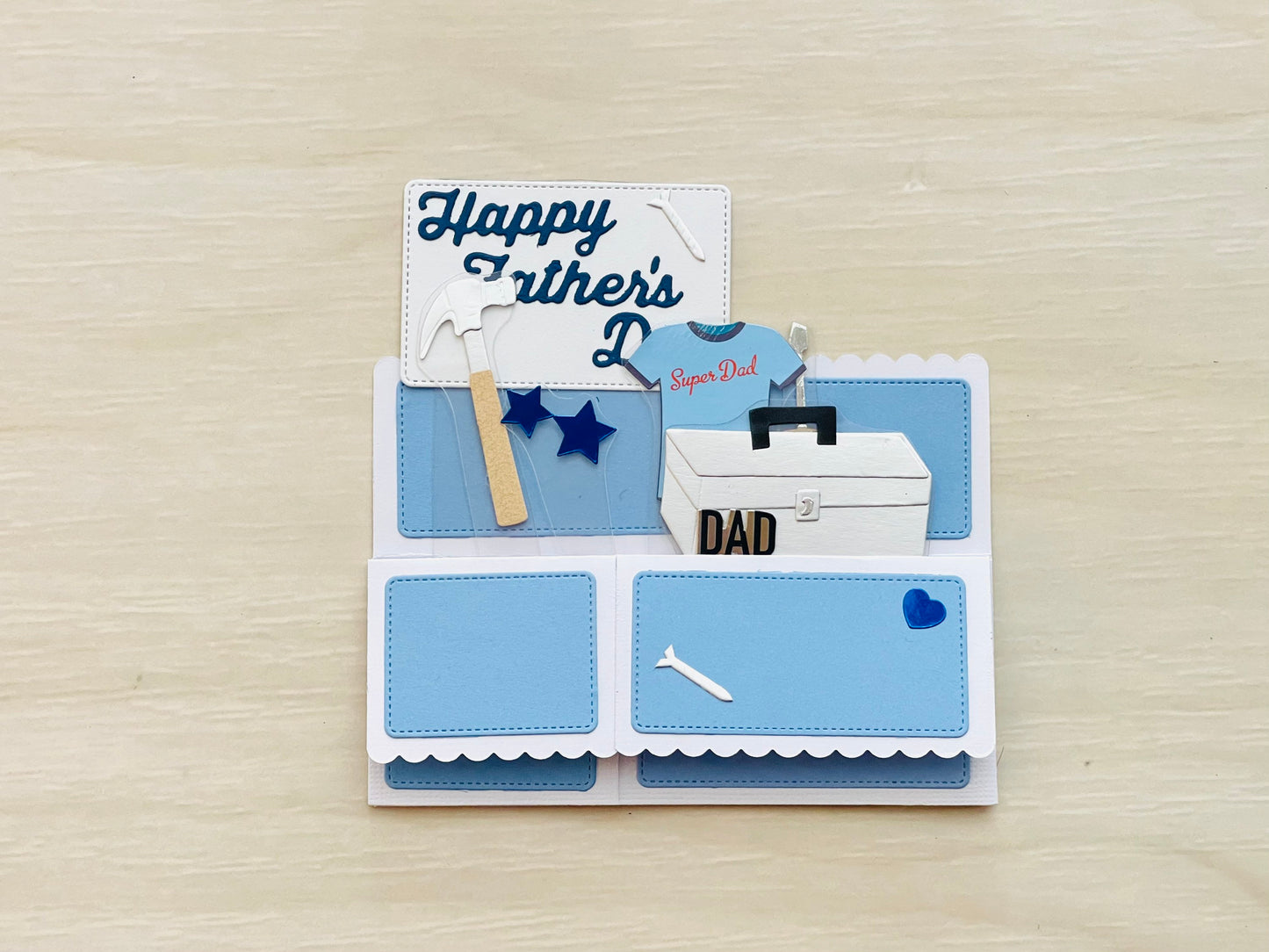 Father's Day card with toolbox and tools on a wooden surface