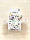 Colorful Mother's Day card with a pop-up design on a wooden surface