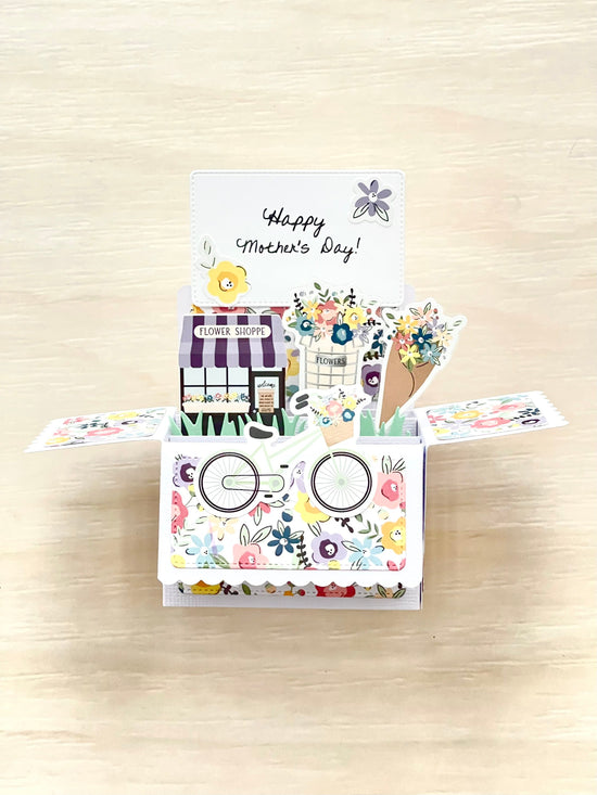 Colorful Mother's Day card with a pop-up design on a wooden surface