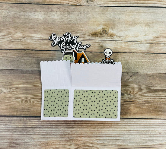 Spooky Good fun Halloween-themed pop-up card with decorative elements on a wooden background
