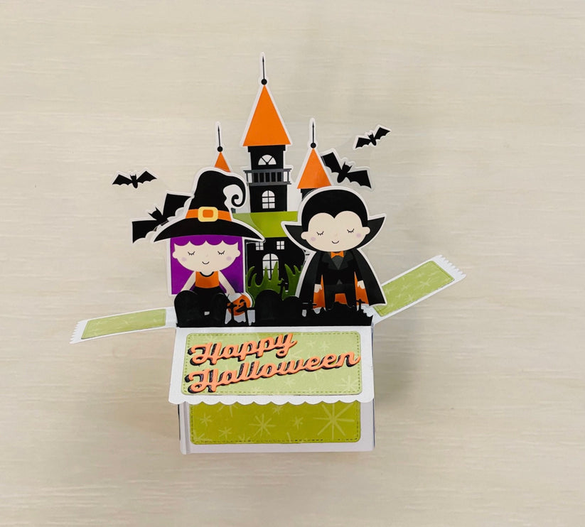 Halloween-themed pop-up card with cartoon characters and a castle on a beige background