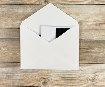White envelope with a card on a wooden surface
