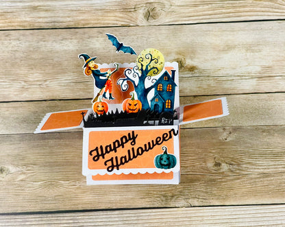 Halloween-themed pop-up card on a wooden surface