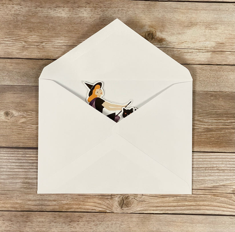Halloween card inside of an open envelope on a wooden surface